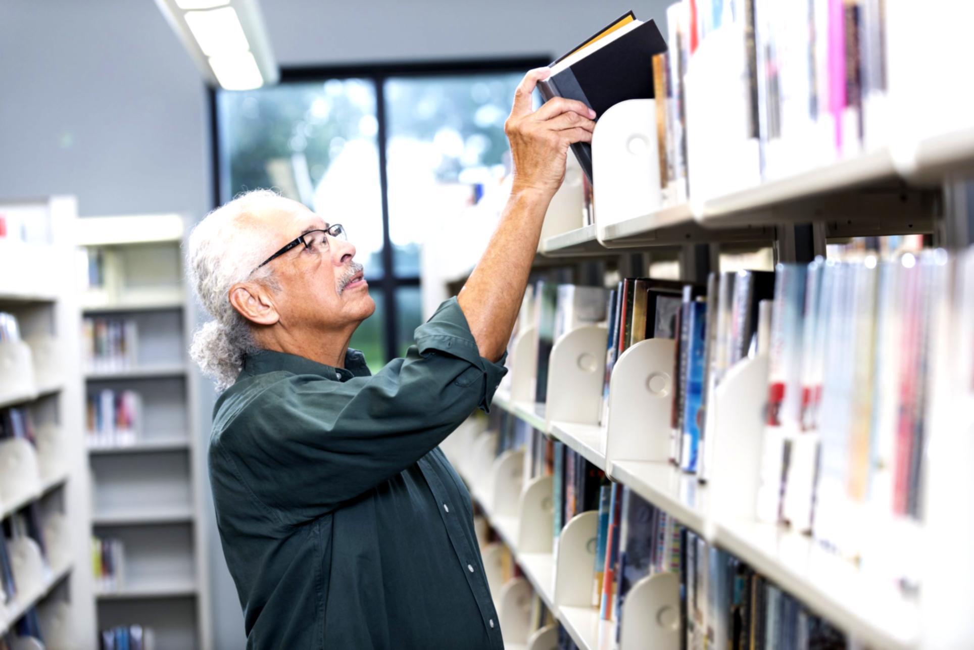 Student reviewing budget worksheet with calculator and notes